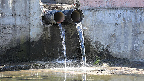 Dirty Water Pouring out of Pipes